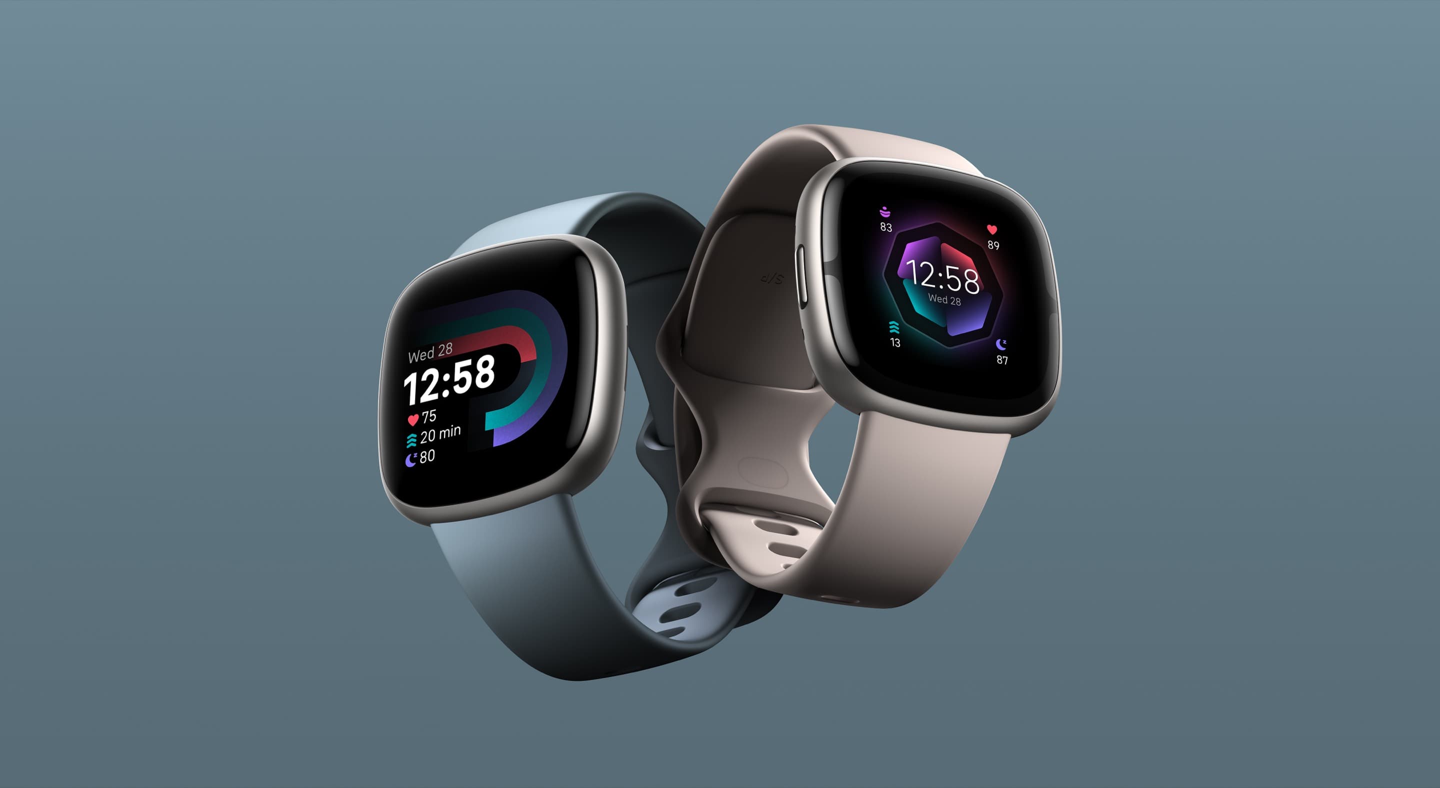 Versa 4 in waterfall blue and Sense 2 in lunar white side by side on a slate background